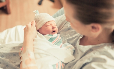 woman holding newborn baby